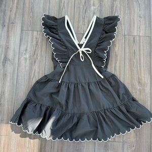 Black Dress with White Scalloped Trim and Bow